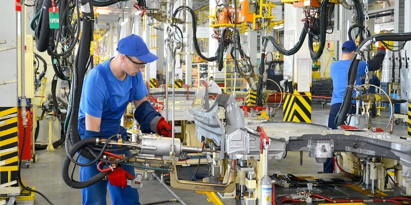 Workers work in a factory where the kaizen method is used