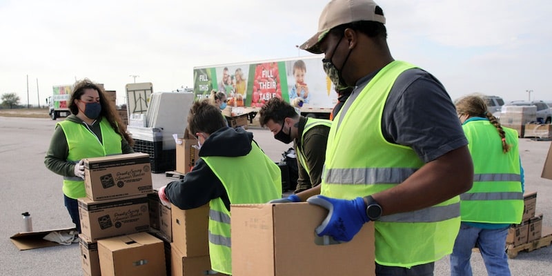 A group of volunteers transports donations.