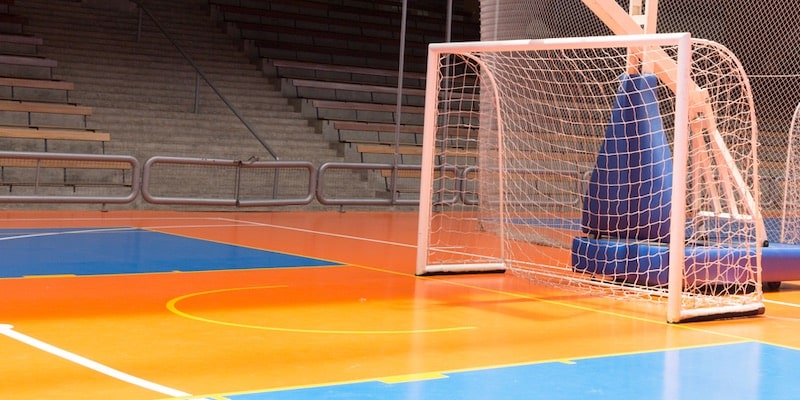 In an indoor gym there is an indoor soccer field.