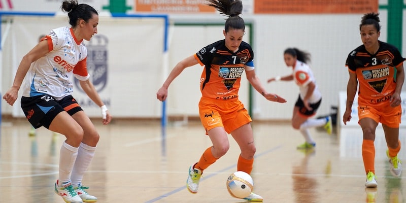 Futsal players compete for control of the ball.