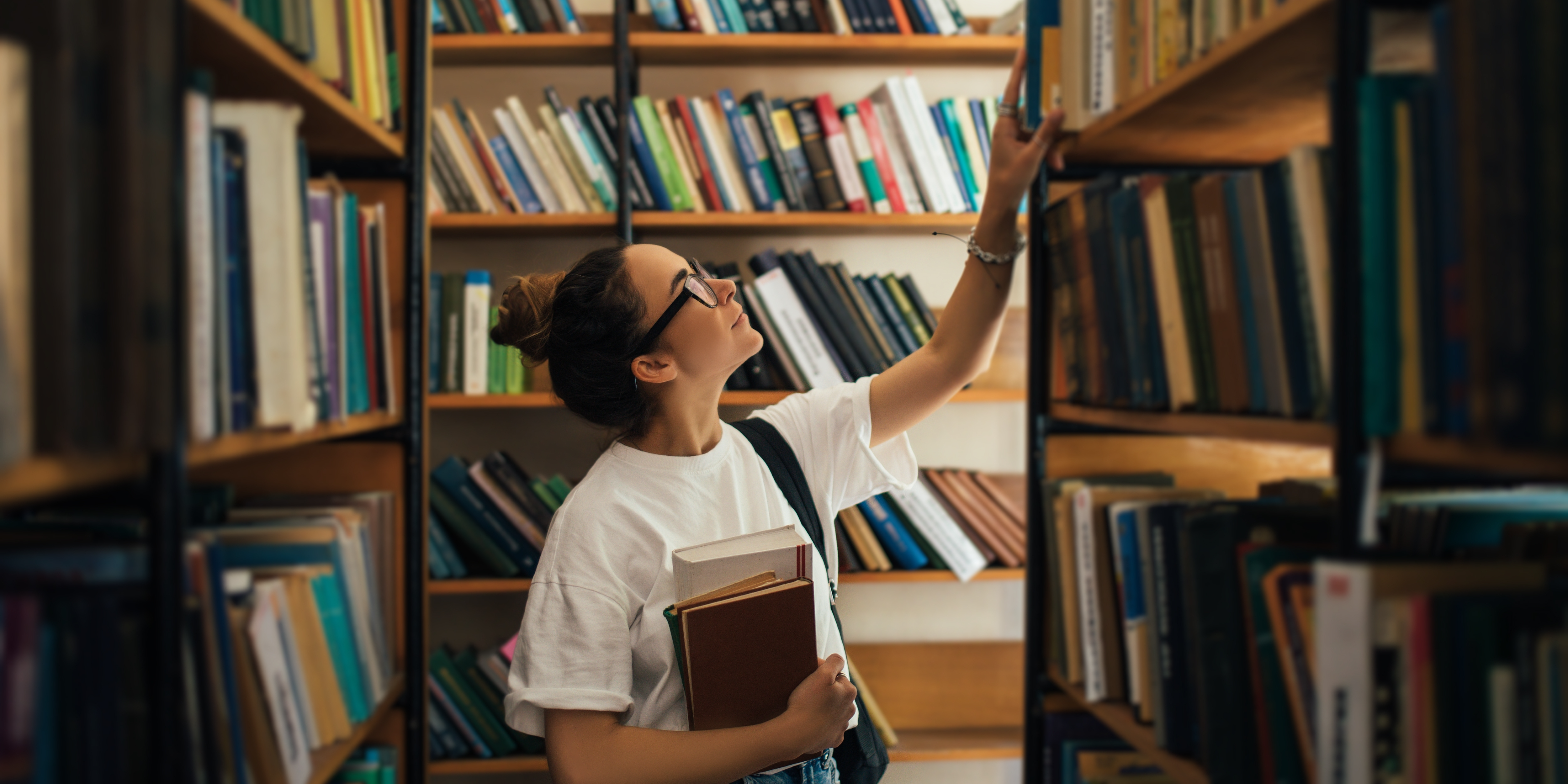 a researcher searches for bibliography in a library