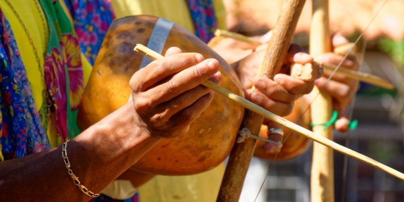 a musician playing the birimbao