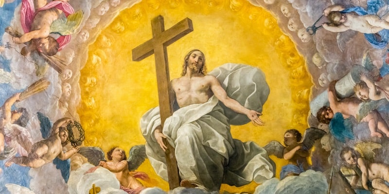 On the dome of a cathedral there is a painting of Jesus holding the cross.