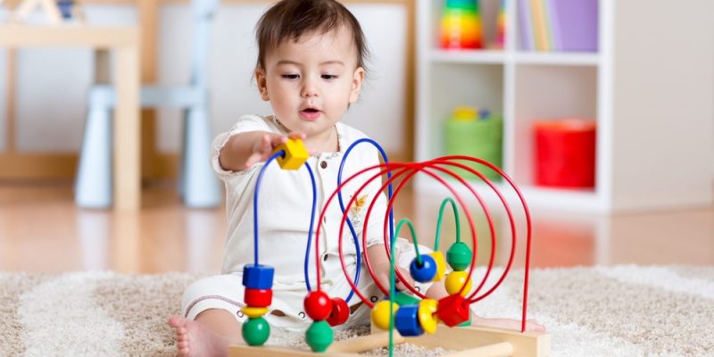 a child plays on a carpet