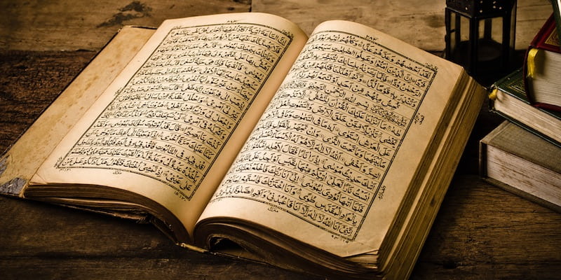 Arabic writing can be seen on the pages of the Koran.