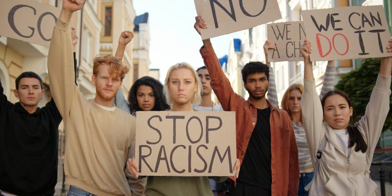 Group of young people with signs against racism