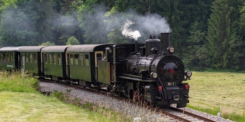 An old locomotive still uses its steam engine.