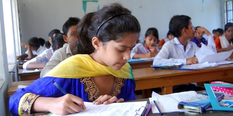 A girl studies in a secular educational institution