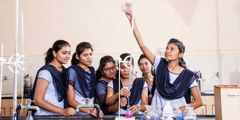 A group of students performs a chemical experiment.