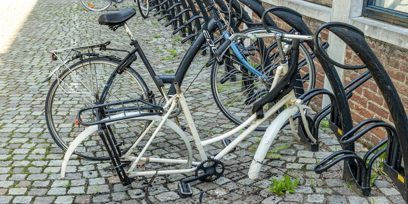 Someone has stolen the wheels of a bicycle.